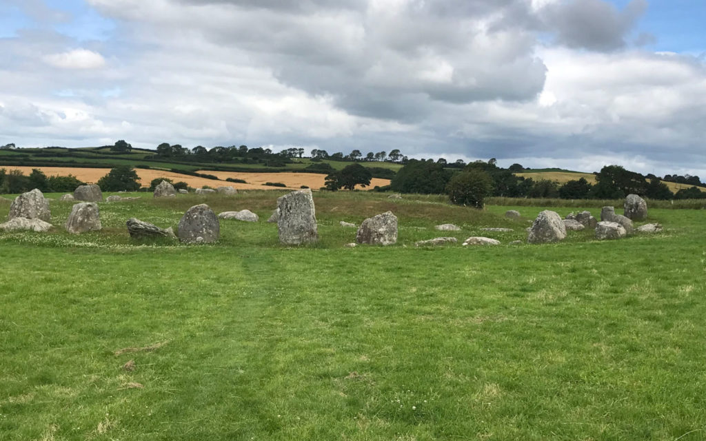 A circle of standing stones in a green field