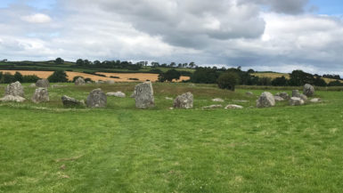 A circle of standing stones in a green field