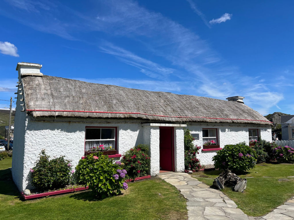 A traditional building at the Folk Village has a thatched roof and whitewashed walls.