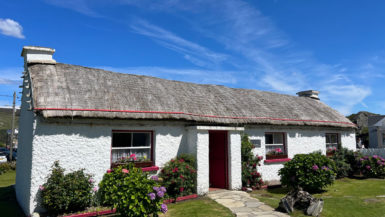 A traditional building at the Folk Village has a thatched roof and whitewashed walls.