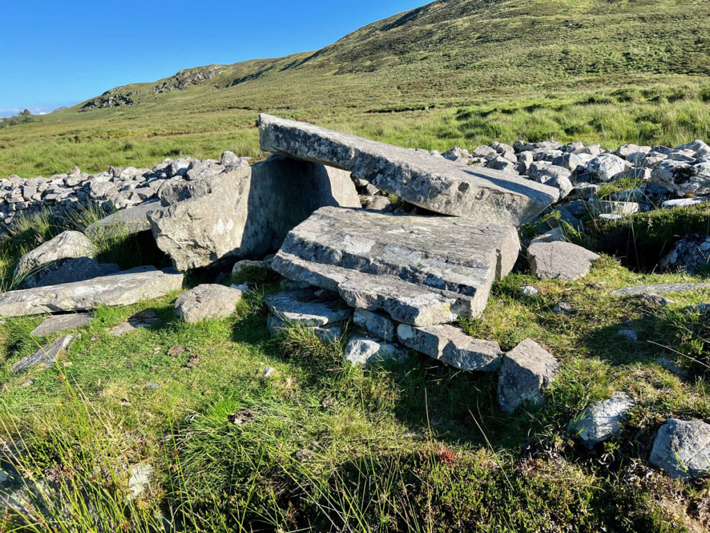 Malinmore Court Tomb is an ancient megalithic tomb that looks like a pile of big rocks.