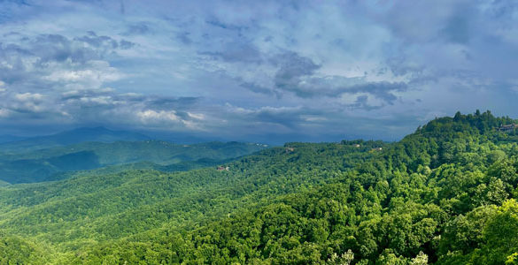 Panoramic view of sky, green trees, and Blue Ridge mountains