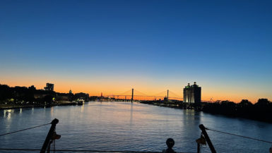 Talmadge Memorial Bridge in Savannah is silhouetted against the sunset as seen from the Georgia Queen Riverboat